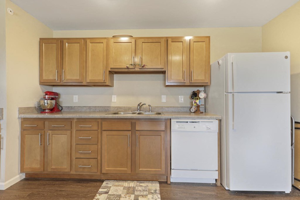 a kitchen with white appliances and wooden cabinets