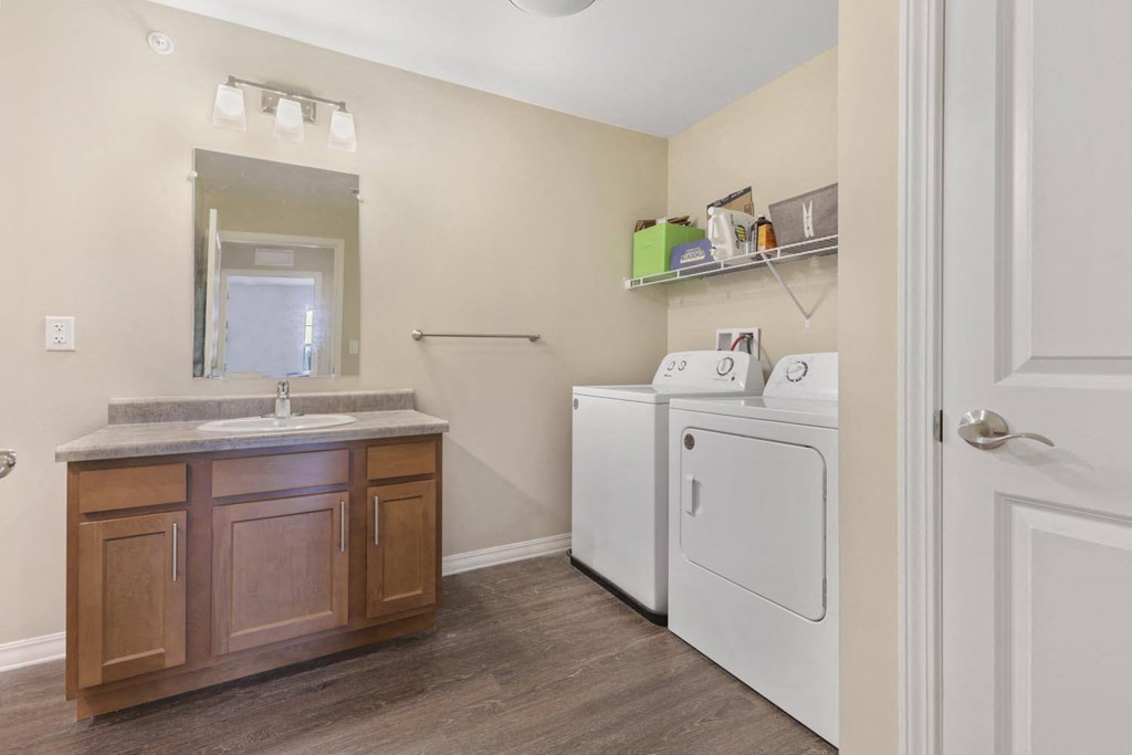 a laundry room with a washer and dryer and a sink