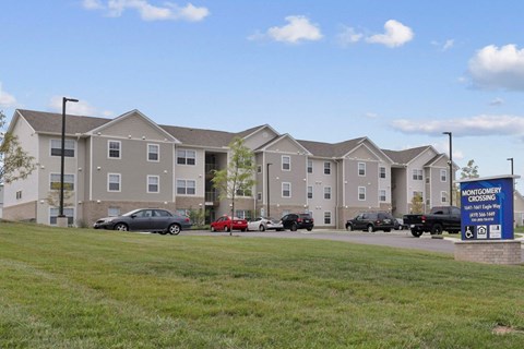 a large apartment building with cars parked in front of it