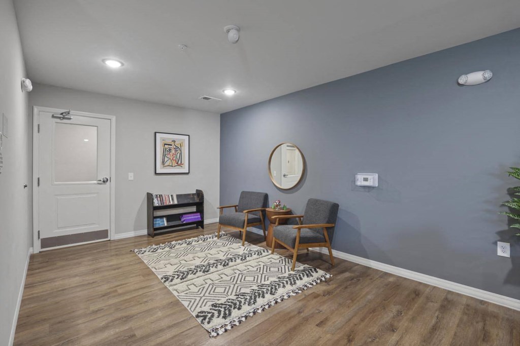 a living room with blue walls and a rug