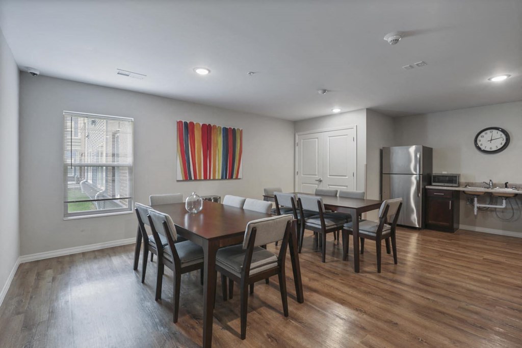 a kitchen and dining room with a table and chairs