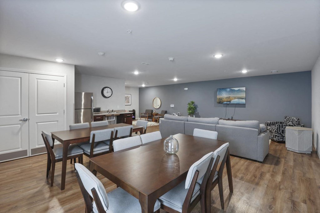 a living room and dining room with couches and tables