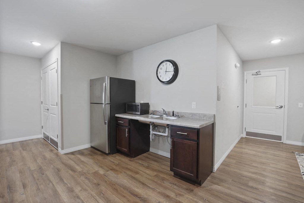 a kitchen with a refrigerator and a sink