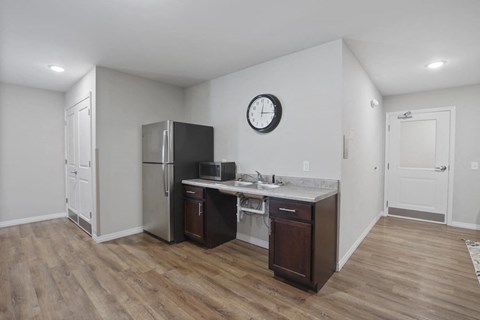 a kitchen with a refrigerator and a sink