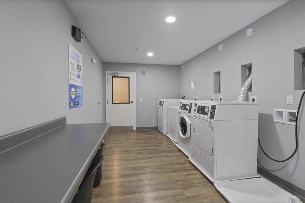 a laundry room with washing machines and a table