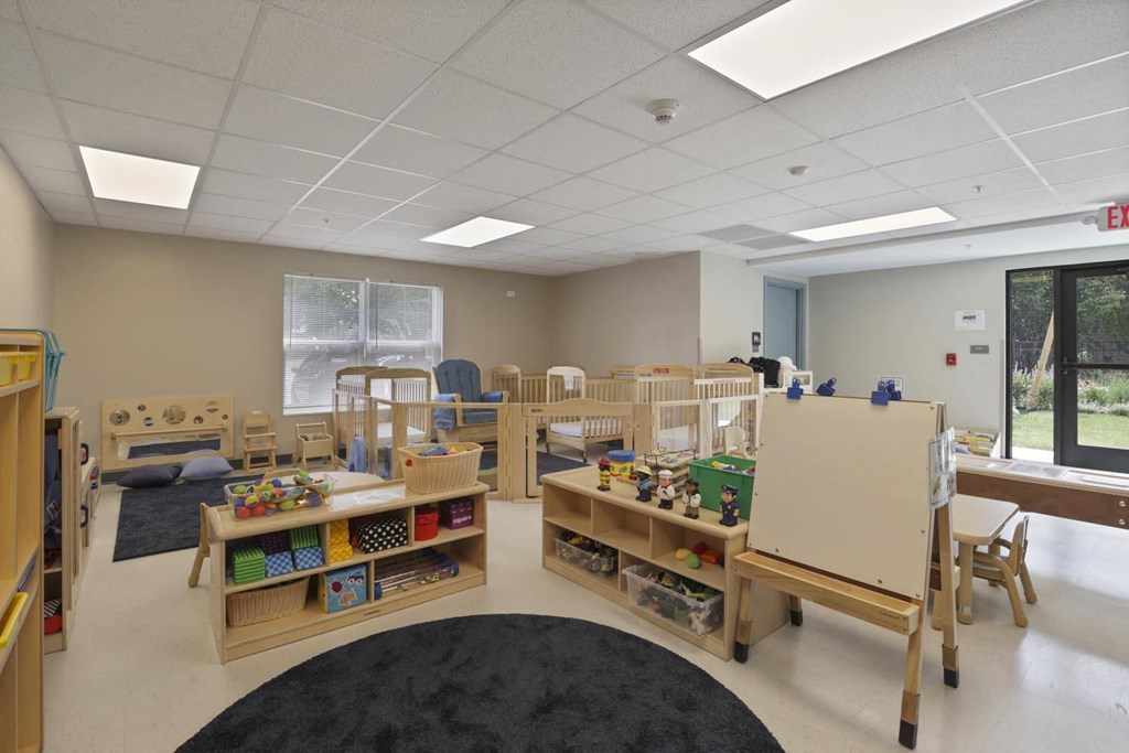 a childrens play room with wooden furniture and toys