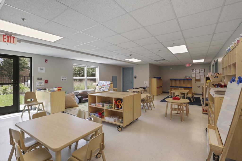 a classroom in a school with tables and chairs