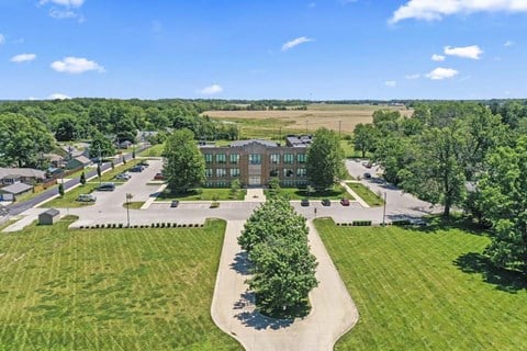 an aerial view of a large building in a parking lot