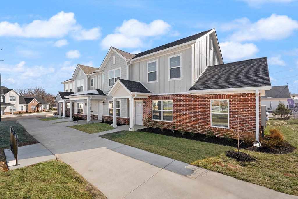 A row of houses with a clear blue sky above them.