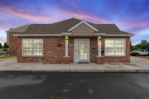 the front of a brick house with a white door