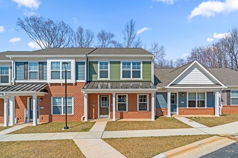 A row of houses with a clear blue sky above them.