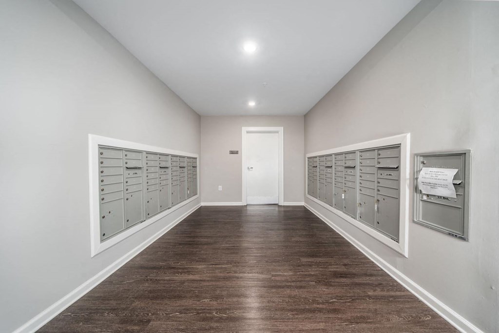 a long room with a bunch of mailboxes on the wall