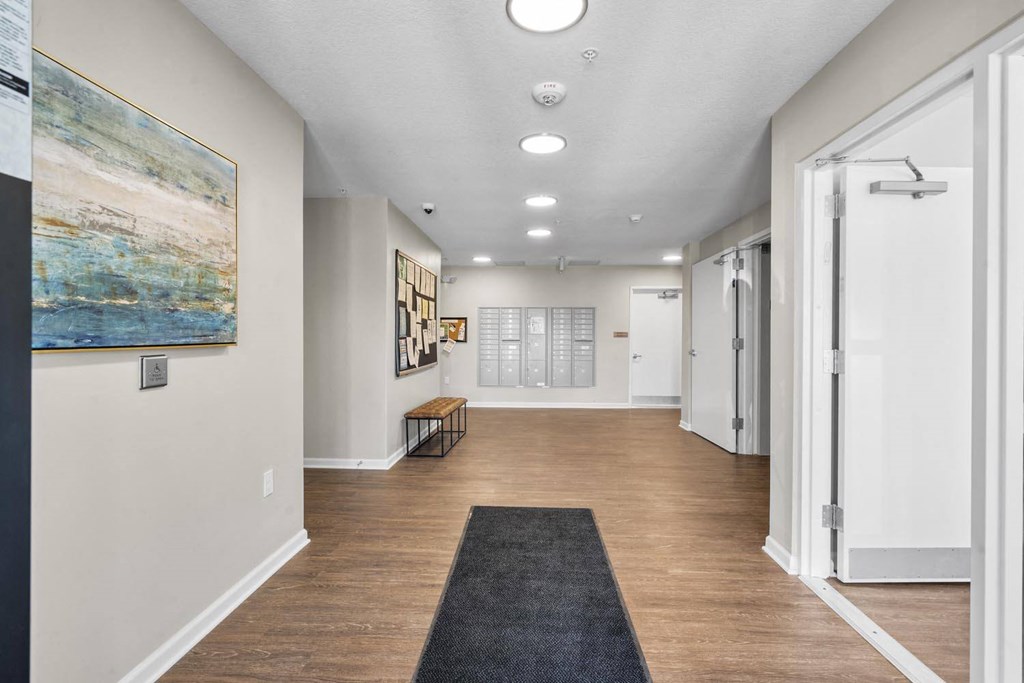 a long hallway with white walls and wood floors