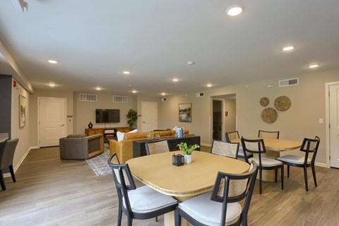 A dining room with a round table and chairs.