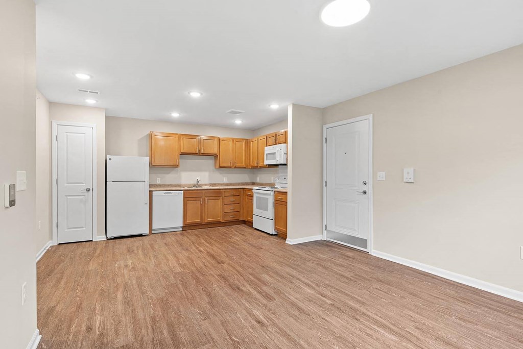 A kitchen with wooden cabinets and a white refrigerator.