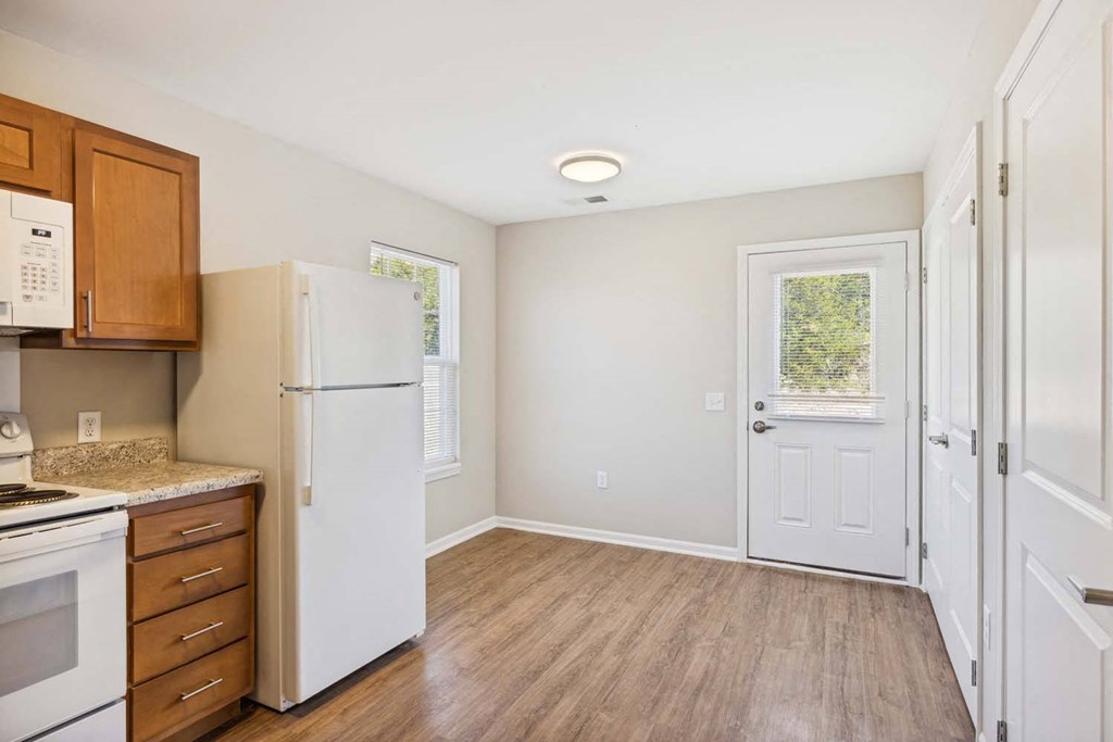 a kitchen with a refrigerator and a door