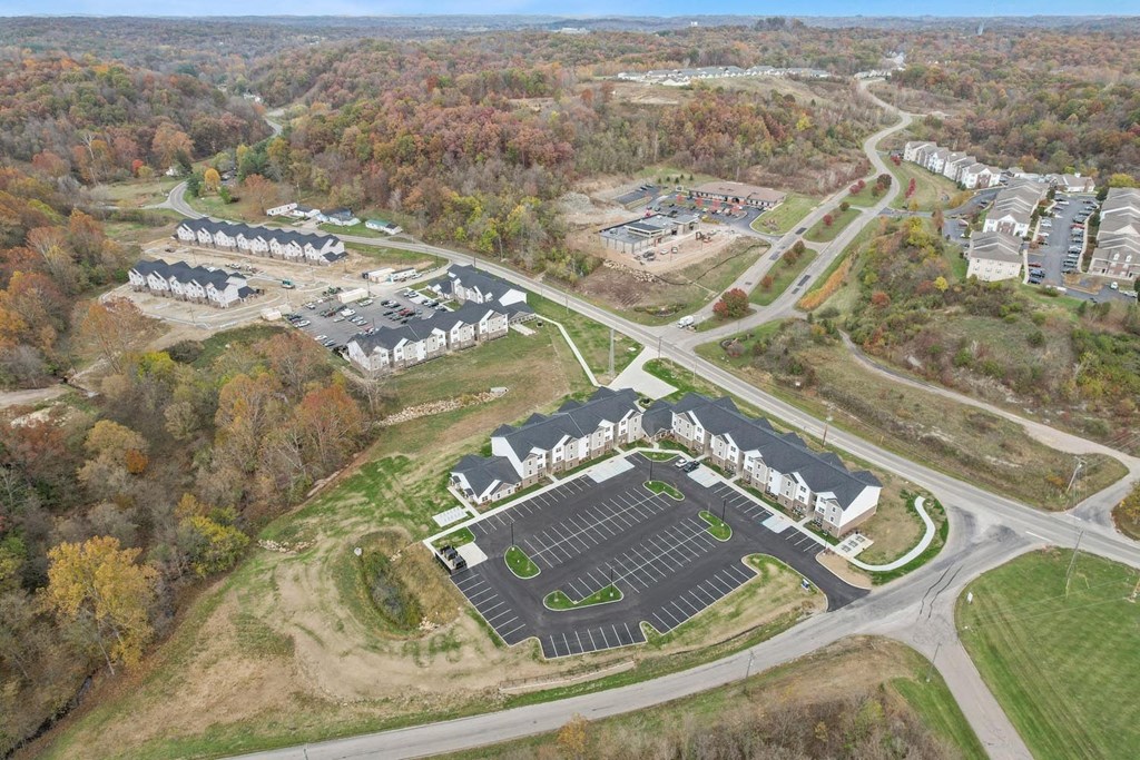 an aerial view of a campus with buildings and a road