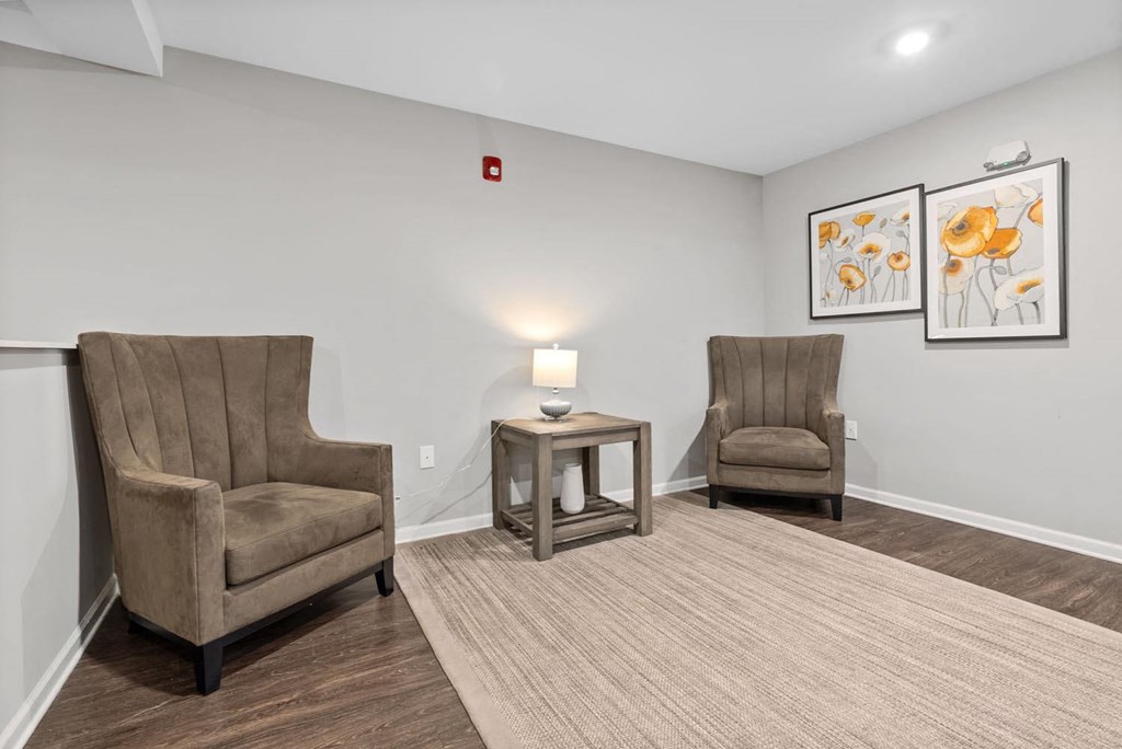 a living room with two chairs and a table