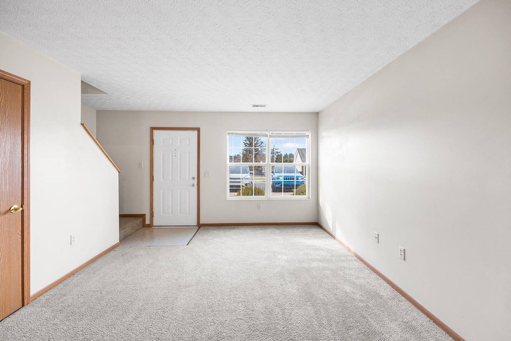 a empty room with a door and a window
