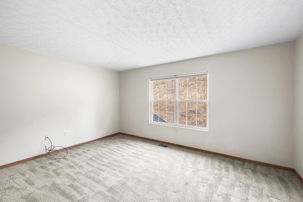 an empty living room with a large window