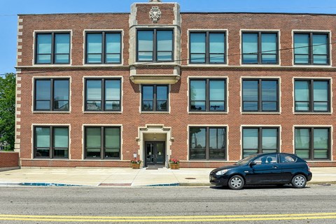 a car parked in front of a brick building