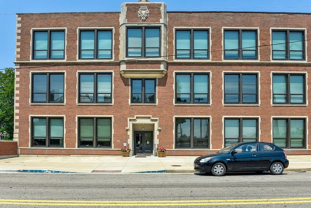 a car parked in front of a brick building