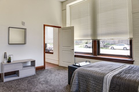 a bedroom with a bed and a window
