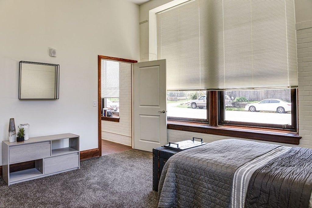 a bedroom with a bed and a window