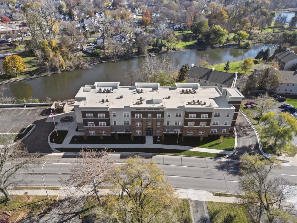 an aerial view of a building next to a river