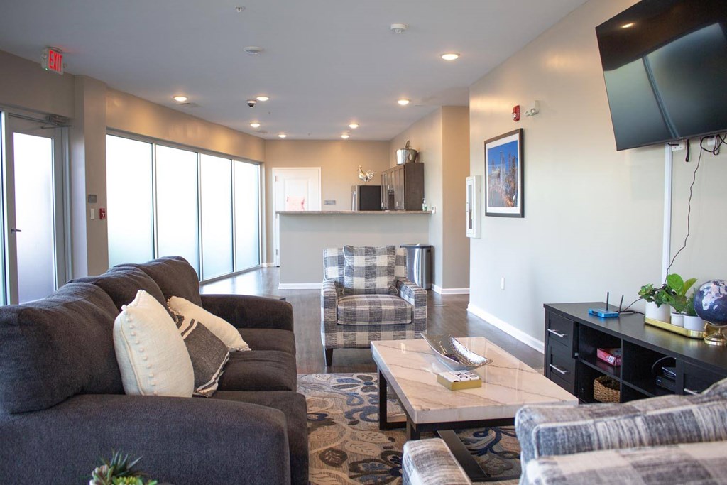 A living room with a grey couch and a coffee table.