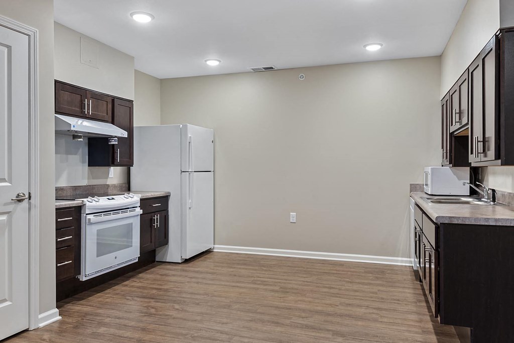 a kitchen with a refrigerator and a stove and