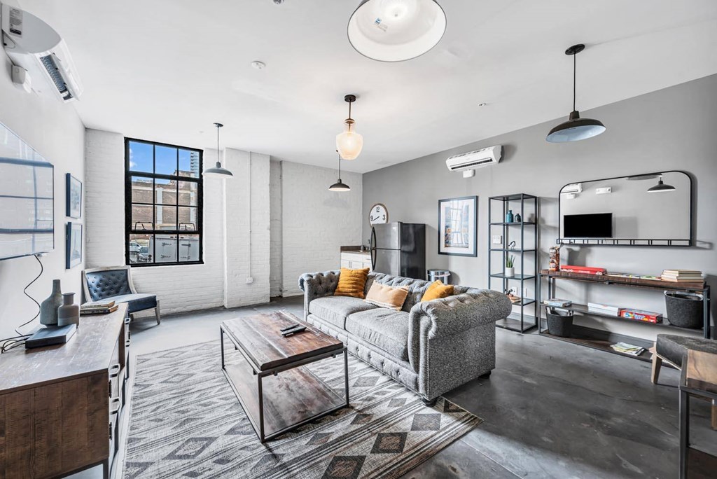 a living room with a gray couch and a coffee table