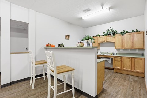 A kitchen with white cabinets and a white counter top.