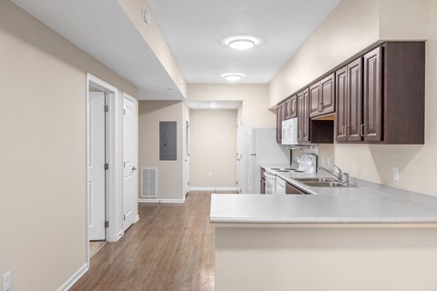 a kitchen and living room with a white counter top