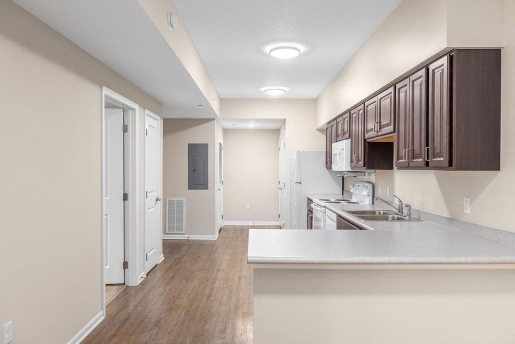 a kitchen and living room with a white counter top
