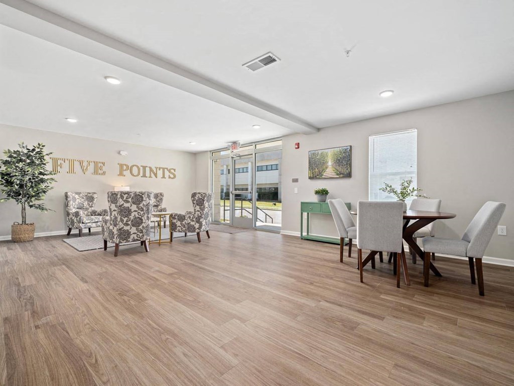 a living room and dining room with a table and chairs