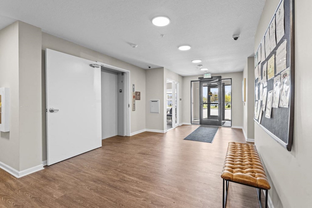 a hallway with white walls and a white door