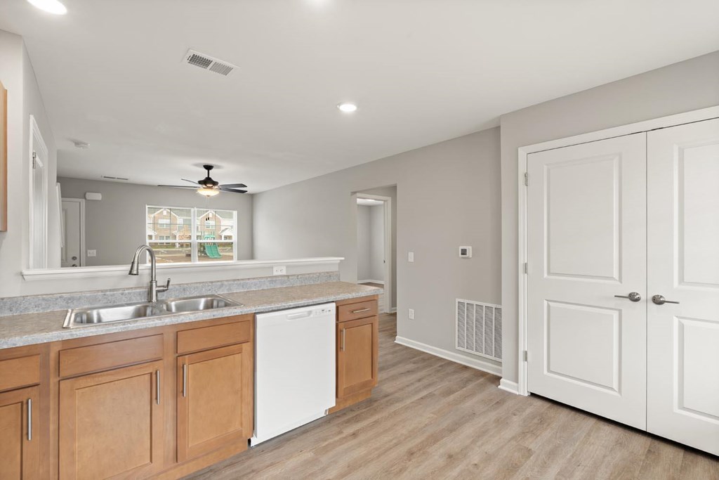 A kitchen with wooden cabinets and white appliances.