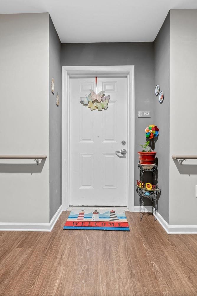 a hallway with a white door and rails