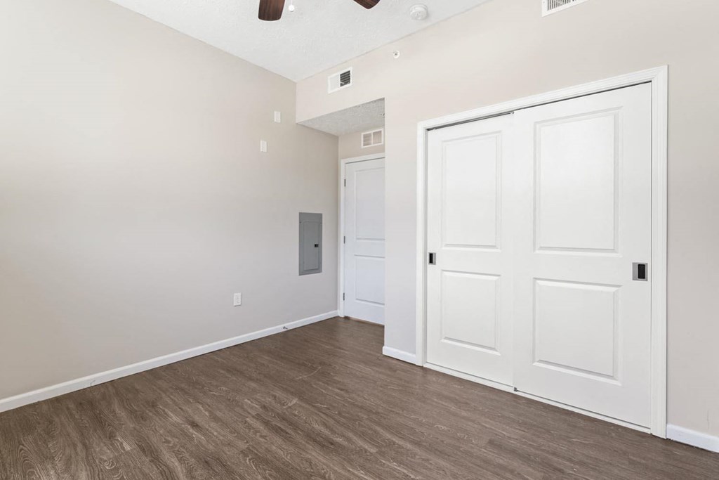 a bedroom with white doors and a door to a closet