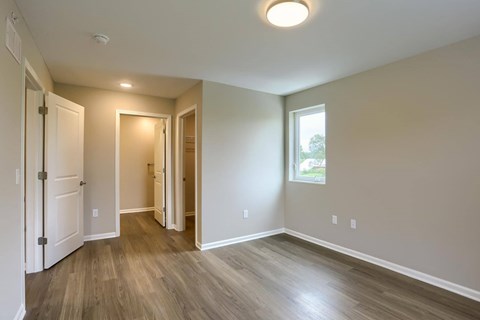 A room with a white door and a window.