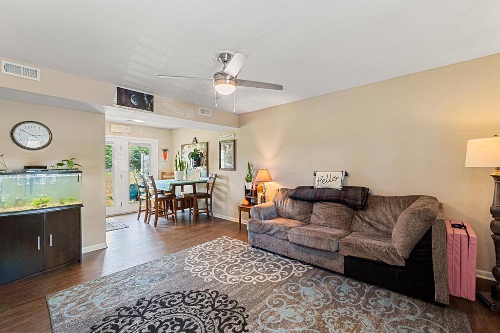 a living room with a couch and a fish tank