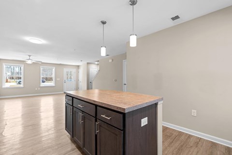 A kitchen with a wooden counter top and cabinets.