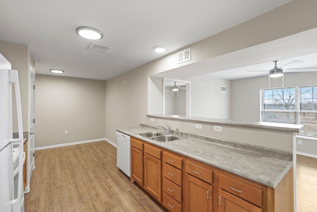 an empty kitchen with a sink and a window