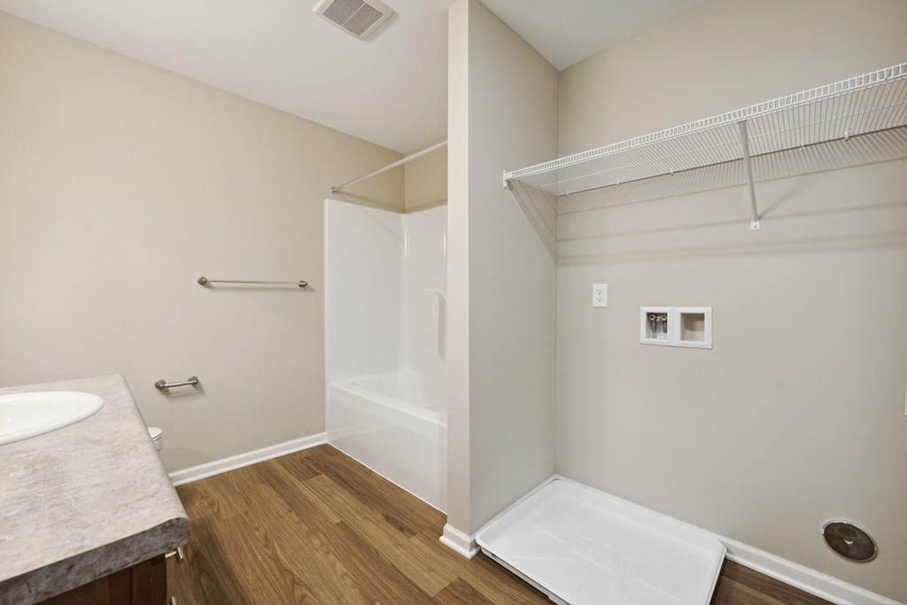 a bathroom with a shower and a sink