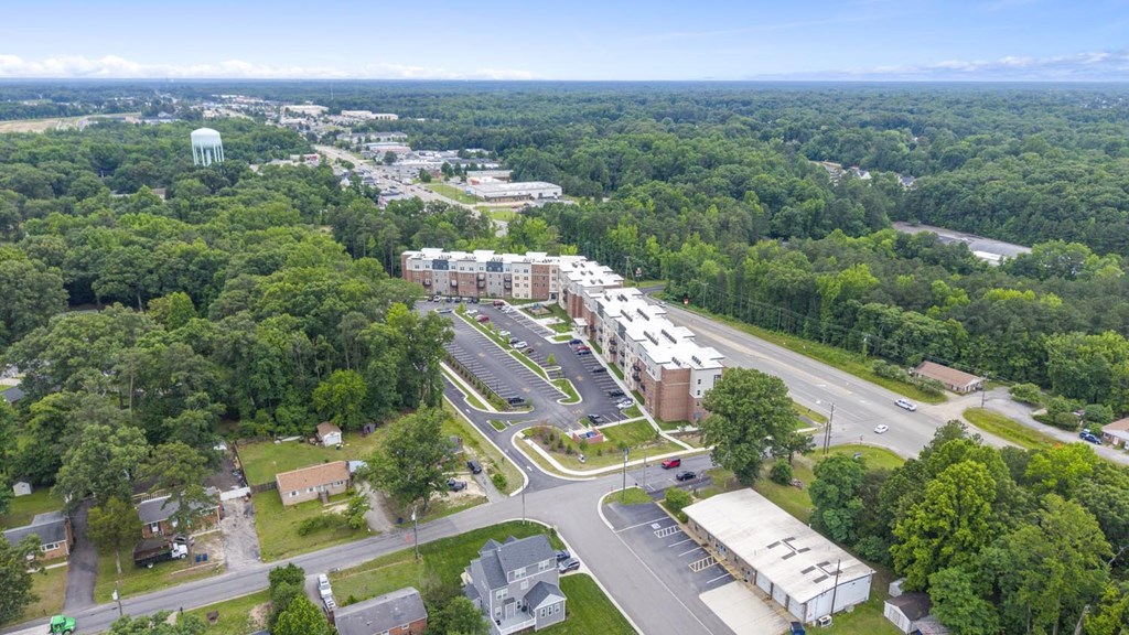 A bird's eye view of a town with a large green area in the foreground.