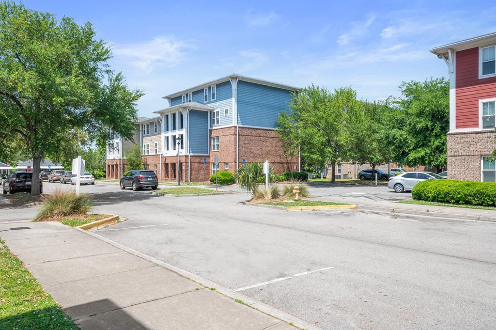 an empty street in front of an apartment building