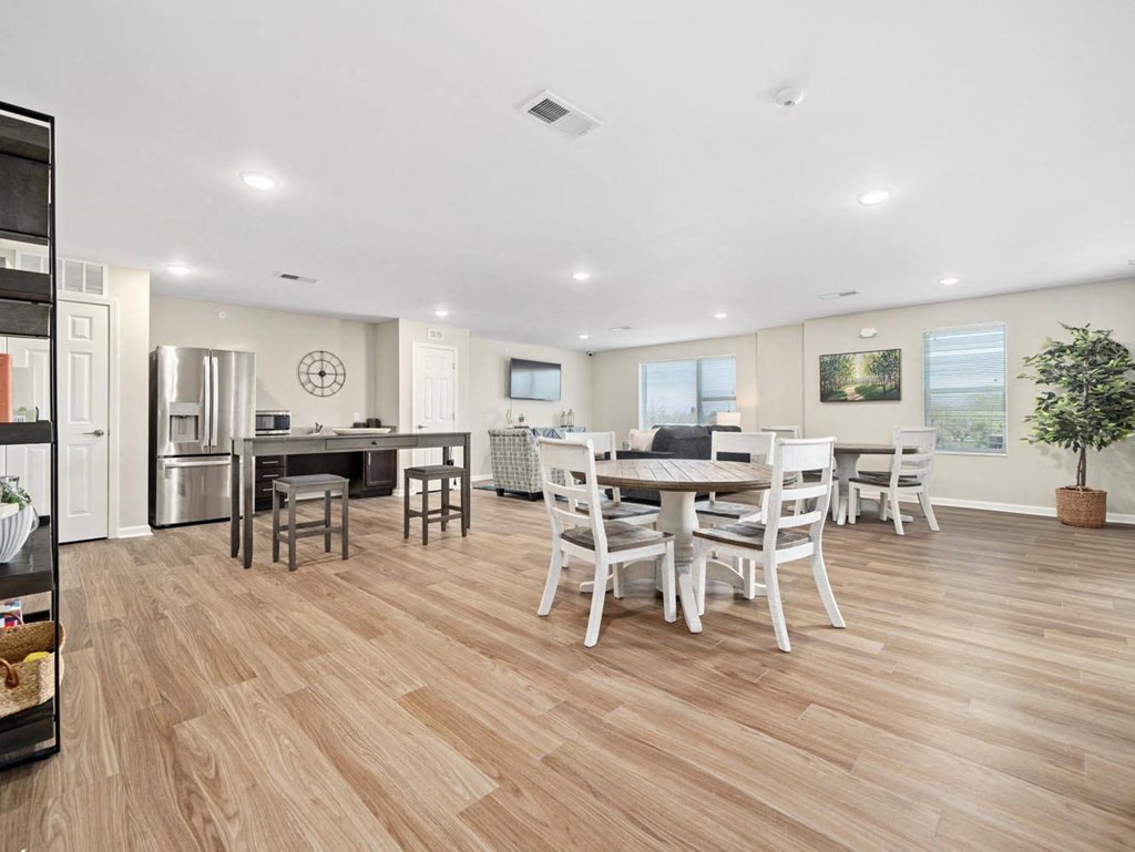 a kitchen and dining room with a table and chairs