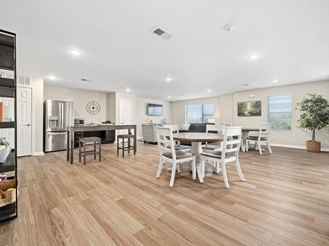 a kitchen and dining room with a table and chairs