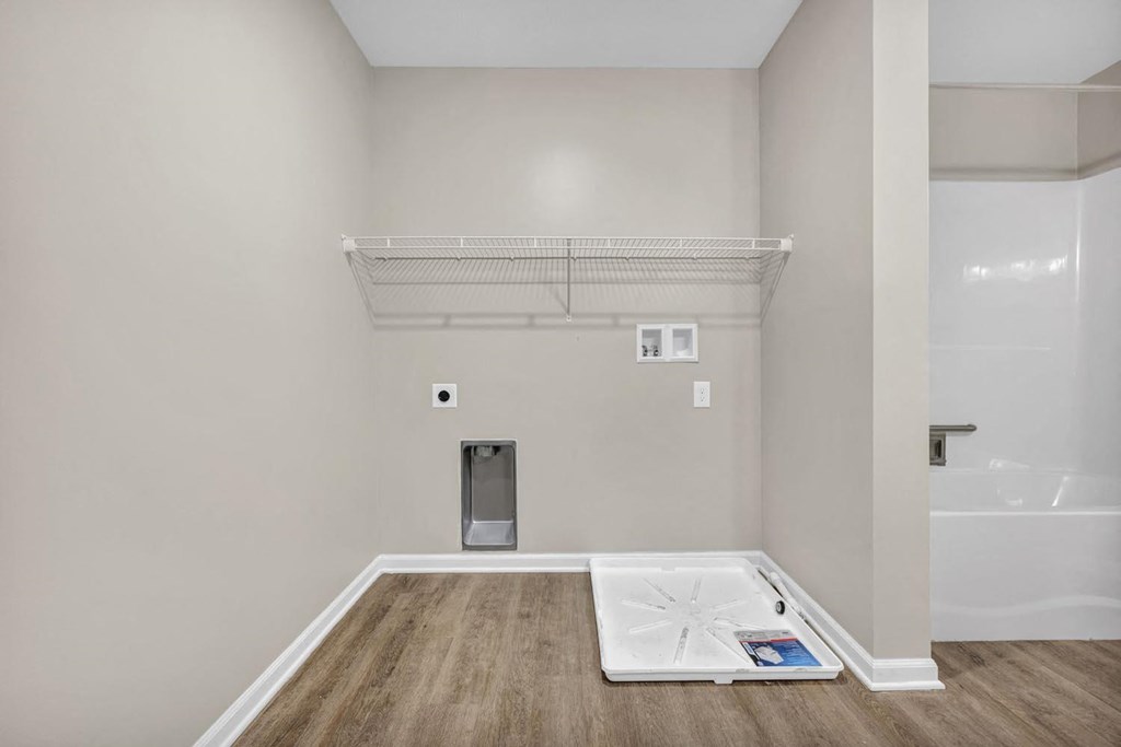 the room is empty and there is a white floor and a closet